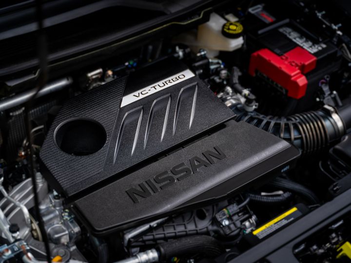 The engine inside the 2025 Nissan Rogue rock creek, the engine cover is black and has Nissan written on the top.