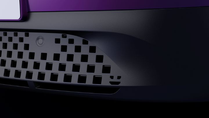 Photograph shows close-up of a car front bumper. Cropped composition emphasizes pixel-inspired circular control, curved edge, and a robot face.
