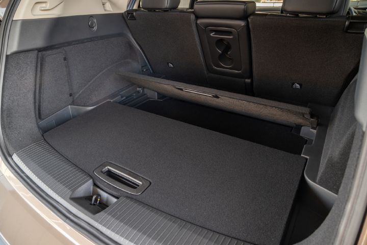 View into the Nissan X‑Trail luggage compartment with the rear seats up and the luggage area split with dividers