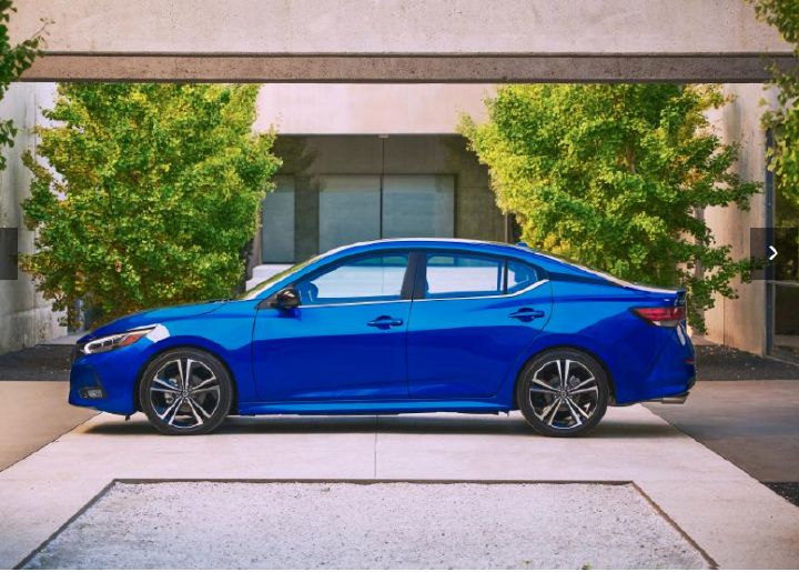Driver side view of a blue Nissan model