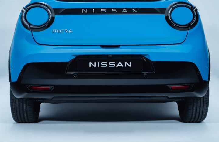 low rear view of Micra rear revealing black bumper, nissan name plate, micra badge and rear signature lamps