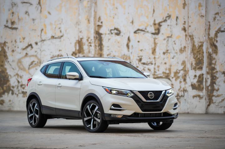A white 2022 Nissan Rogue Sport parked in front of a wall