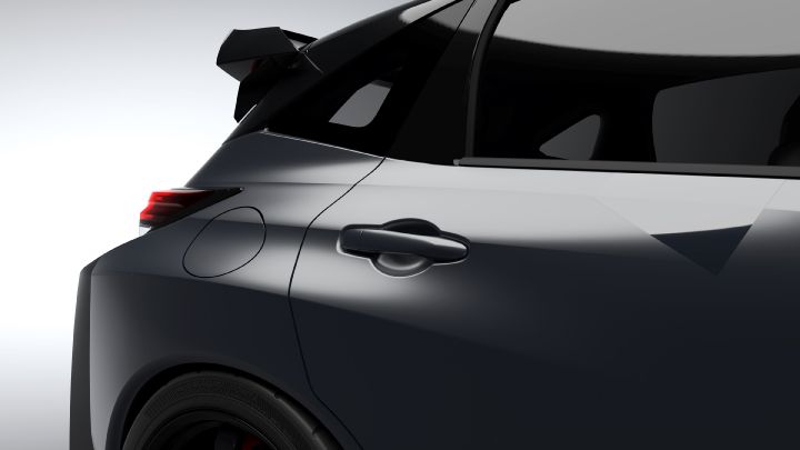 A close-up studio shot of the rear door and back section of the Aura Nismo RS Concept, a silver and black two-tone sports car. The image shows the door handle, rear fender, and part of the large rear wing. The smooth curves and glossy finish of the body are highlighted against a light gray background, emphasizing the car's refined design.