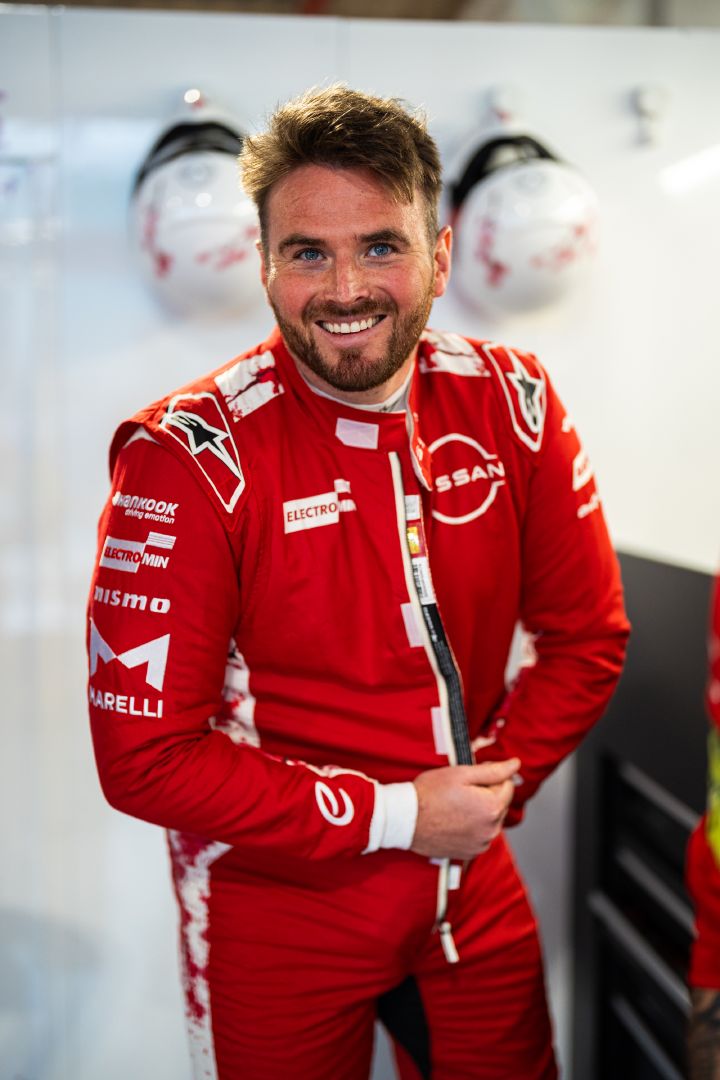 Porträtfoto von Oliver Rowland in seinem roten Rennanzug des Nissan Formula E Teams, während er sich auf eine Trainingseinheit in Miami vorbereitet.
