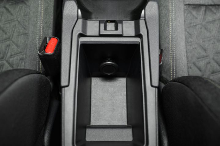 The center console storage space inside the 2026 Nissan Kicks.