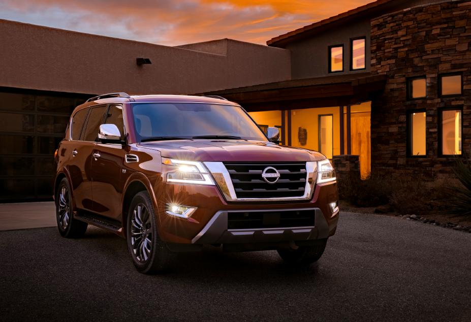 Parked 2022 Nissan Armada with it's headlights on at night.