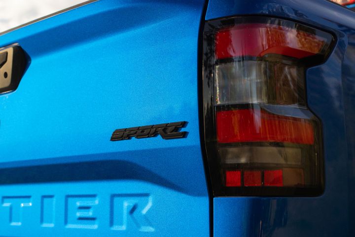 Close up of the right taillight and truck bed decal that reads "SPORT" on the 2027 Nissan Frontier Sport Edition.