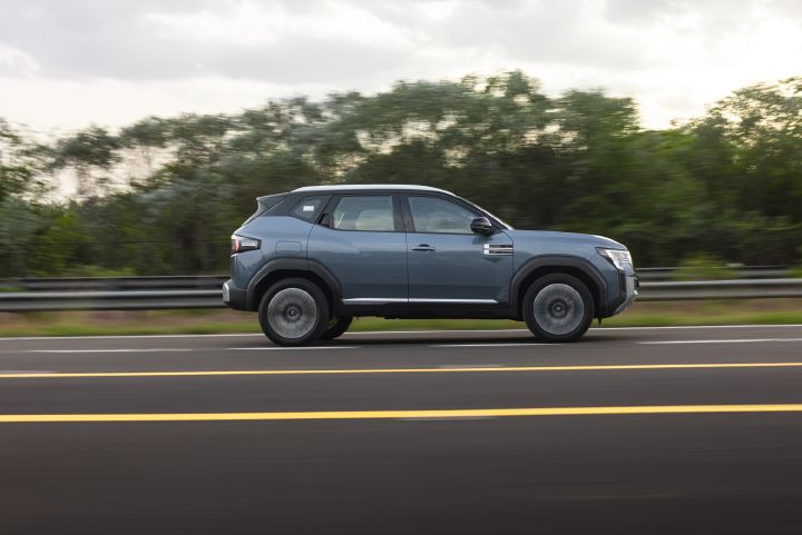 Side profile of the Nissan Tekton driving along a highway.