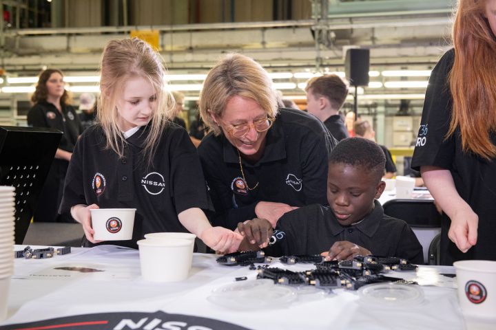 Friederike Kienitz with two schoolchildren who are building Nissan Lego Qashqai during the Nissan Skills Foundation event