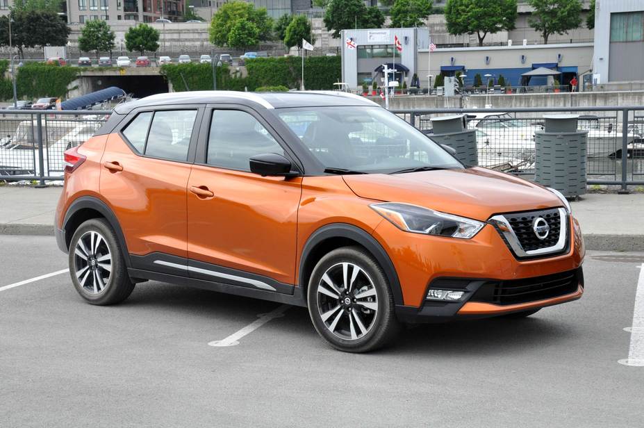 An orange Nissan Kicks parked in a parking lot