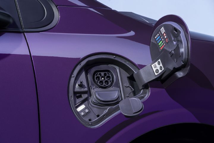 Photo shows open fuel-filler compartment on a glossy purple car, highlighting vehicle refueling components.