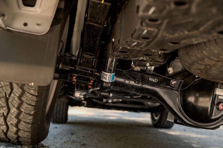 2026 Nissan Navara ST dual cab ute finished in Summit Silver detailed from underneath, highlighting the rear axle, suspension hardware, differential housing and chassis components.