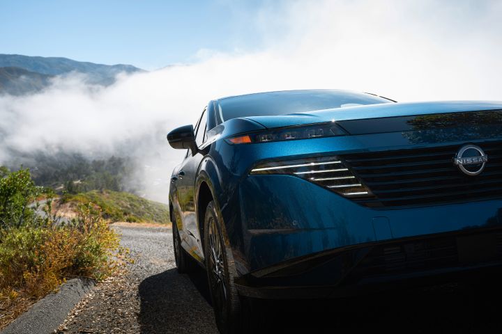 Angled close up of the 2026 Nissan Murano driving through high altitude vapor.