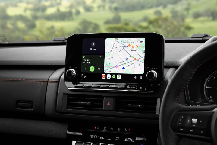 2026 Nissan Navara PRO-4X finished in Boulder Grey focusing on the infotainment display with map guidance, media tile and smartphone app shortcuts.