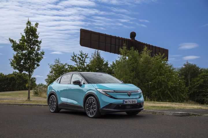 A teal 2026 Nissan LEAF parked with the famous Angel of the North sculpture in the background