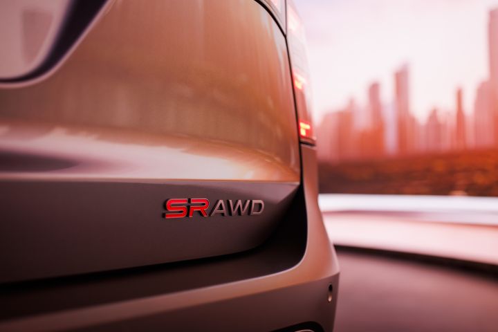 Close-up of the "SR All Wheel Drive" decal on the 2025 Nissan Kicks by the bottom corner of the hatchback.