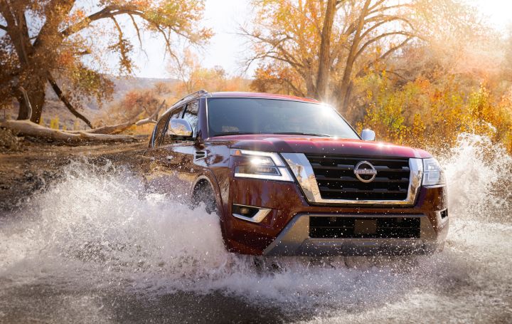 Front right view of the 2021 Nissan Frontier driving through water.