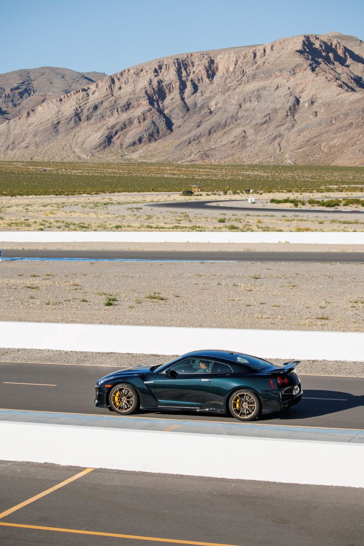Profile / overheaad view of a 2024 GT‑R Special Edition parked on a race track with a mountain in the background