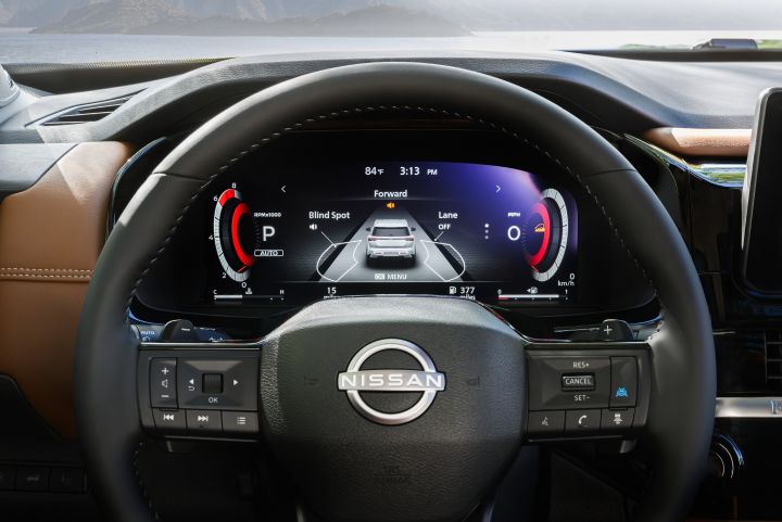 Close up of the steering wheel and driver's dashboard display inside the 2026 Nissan Pathfinder.