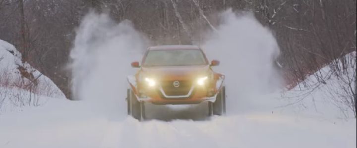 Altima-te AWD driving at the camera kicking up snow