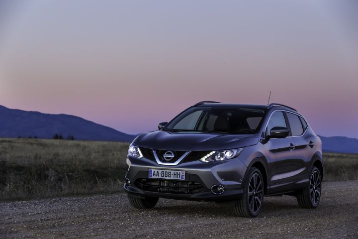 A second-generation Qashqai driving at dusk