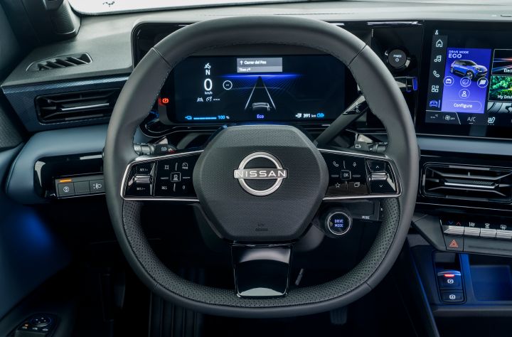 steering wheel detail showing Nissan logo, combimeter and dials