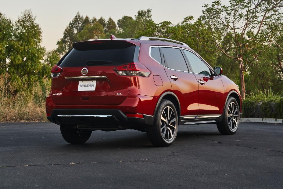 Rear passenger side angled view of a red 2020 Nissan Rogue