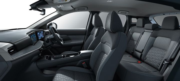 Another angled overhead interior shot of the Nissan Kicks. The cabin layout from front to rear is visible, emphasizing black seats and interior trim.