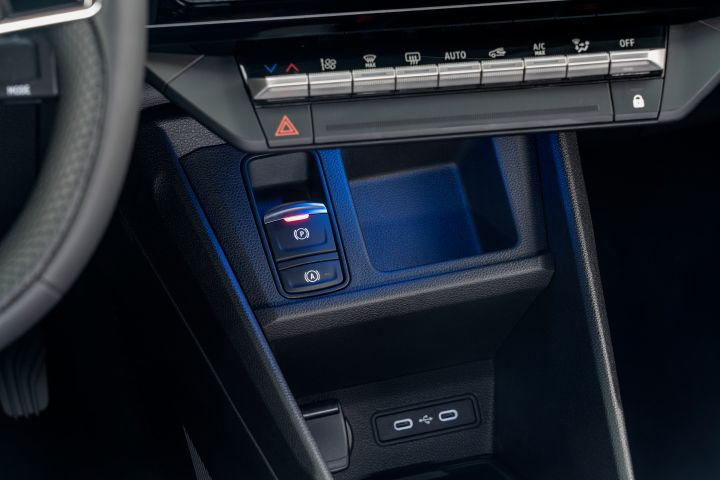 detailed shot of interior console showing air condition buttons, two USB-c ports & storage