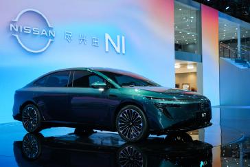 A green colored Dongfeng Nissan N7 EV sedan with blue digital signage ...