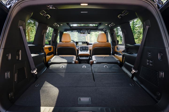 View of the interior from the open hatch back of a 2025 Nissan Armada, the cargo space and folded rear seats can be seen.