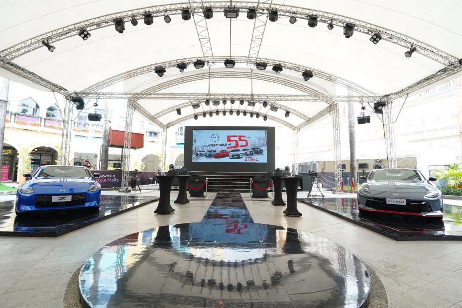 A large white tent with a large screen and a Nissan Z and Z NISMO displayed