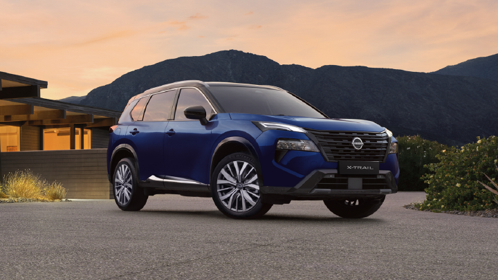 Static left front ¾ exterior image of a blue 2026 Nissan X‑TRAIL SUV