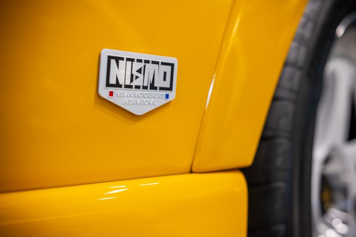A close-up of the NISMO badge on a Yellow colored NISMO 400R.