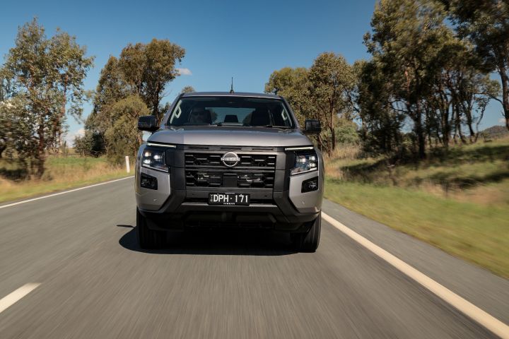 2026 Nissan Navara ST dual cab ute finished in Summit Silver showing the front passenger seat with cloth trim, stitching detail and door panel.