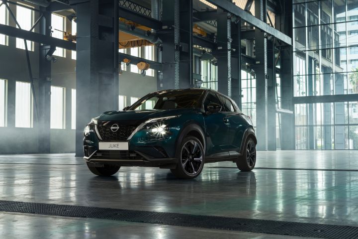 Front three-quarter view of the Nissan JUKE Pulse inside a modern industrial building.