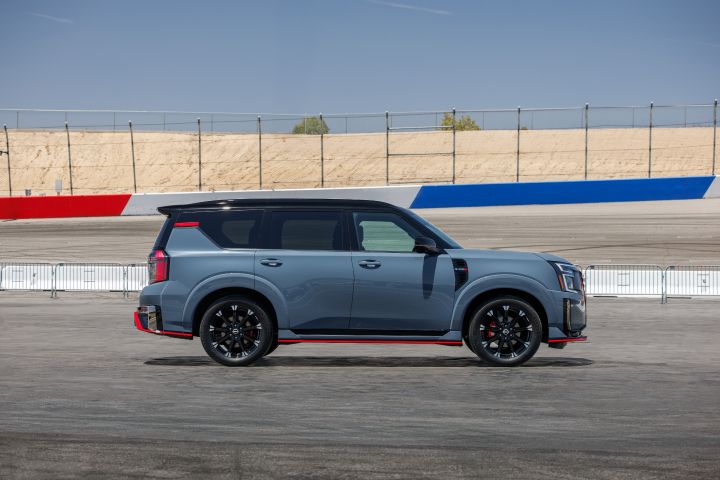Right profile of the 2026 Nissan Armada NISMO parked on a racetrack during the day.