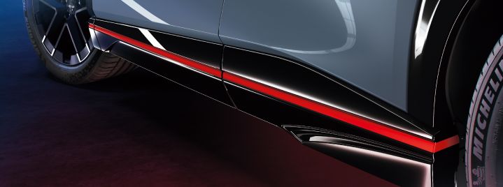 Side shot of Ariya NISMO showing only the bottom edge of the doors (with red line) and 2 wheels