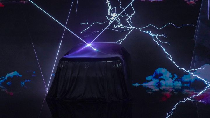 On a dark stage, the all-new Elgrand is covered with a black cloth, with lightning and laser beams projected in the background.