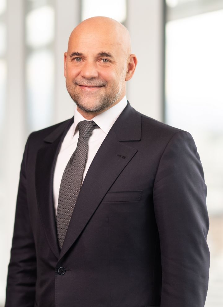 Portrait of Guillaume Cartier (suit, tie and NISSAN corporate pin)