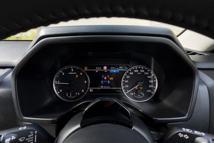 2026 Nissan Navara SL dual cab ute finished in Alpine White with a close view of the instrument cluster, analogue dials, warning lights and central four-wheel-drive status display behind the steering wheel.
