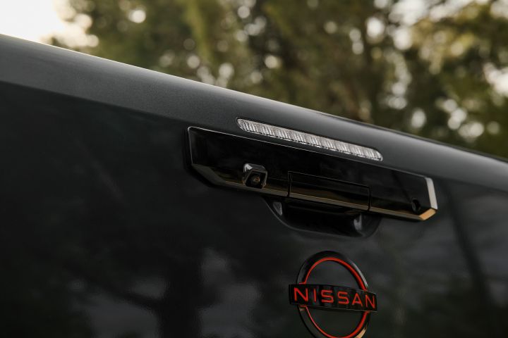 2026 Nissan Navara PRO-4X finished in Boulder Grey focusing on the tailgate handle, integrated reversing camera and slim upper light bar.