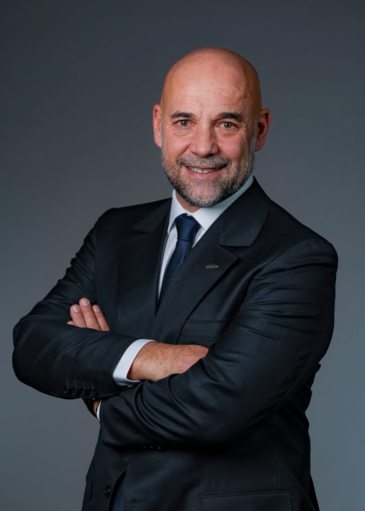 Portrait of Guillaume Cartier (suit, tie and NISSAN corporate pin)