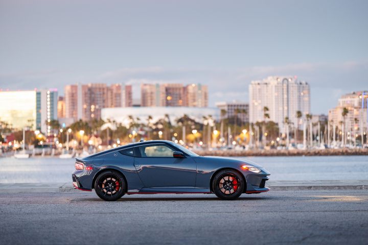 Right profile view of the 2027 Nissan Z NISMO MT parked in front of a cityscape.