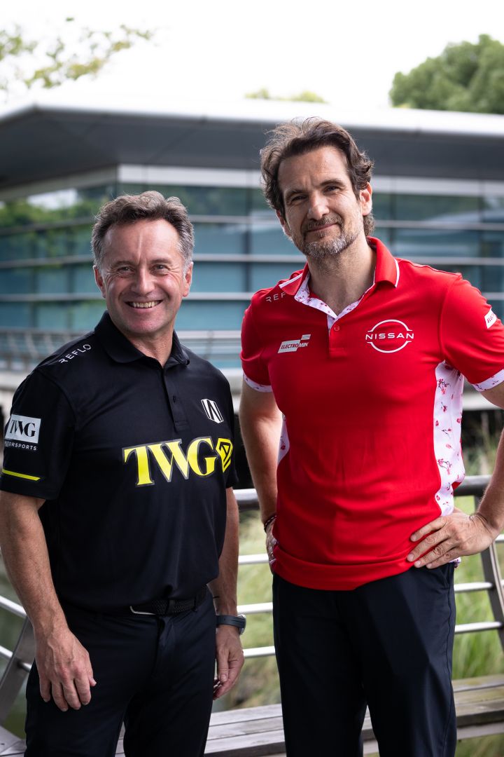 Hochformatiges Bild von Tommaso Volpe, Geschäftsführer und Teamchef des Nissan Formula E Teams, und Roger Griffiths, Teamchef von Andretti Formula E: Beide lächeln, wobei Volpe die Hände in die Hüften gestemmt hat und Griffiths neben ihm steht.
