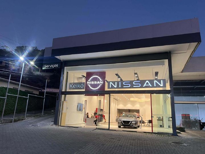 Concessionária da Nissan, localizada em Petrópolis, a noite com algumas pessoas dentro