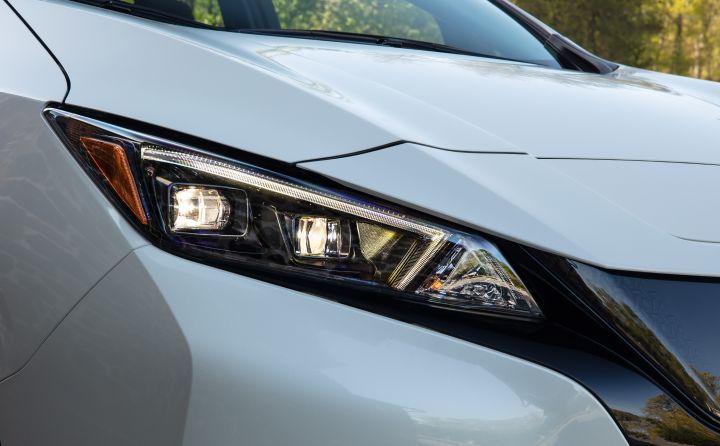 Close up of the front right headlight on a white 2025 Nissan LEAF.