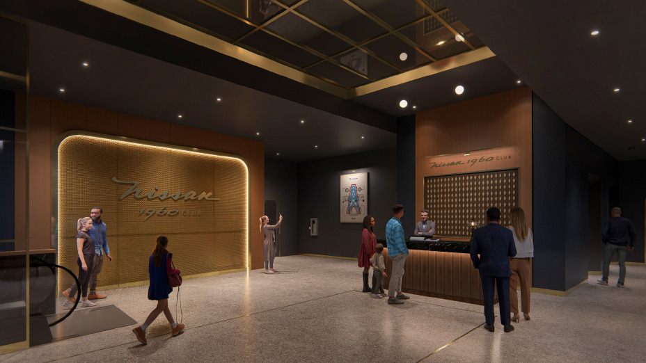 The lobby of a club filled with people and ambient light.
