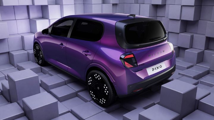 Stylized 3D automotive render presents a purple compact hatchback, for Nissan PIXO vehicle design visualization. Rear three-quarter view shows black panoramic glass, patterned alloy wheels, angular taillights, visible rear badging, and license plate, surrounded by geometric lavender cube walls and floor.