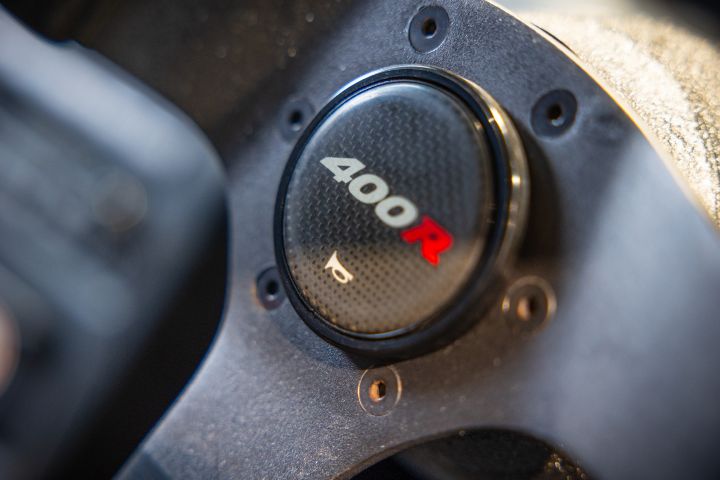 A close up of the 400R horn badge on the steering wheel of a NISMO 400R.
